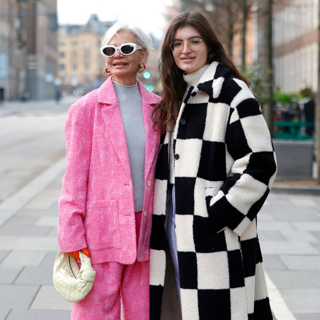 Grece and Cheyenne Ghanem wearing a pink linen suit and a black and white checked coat