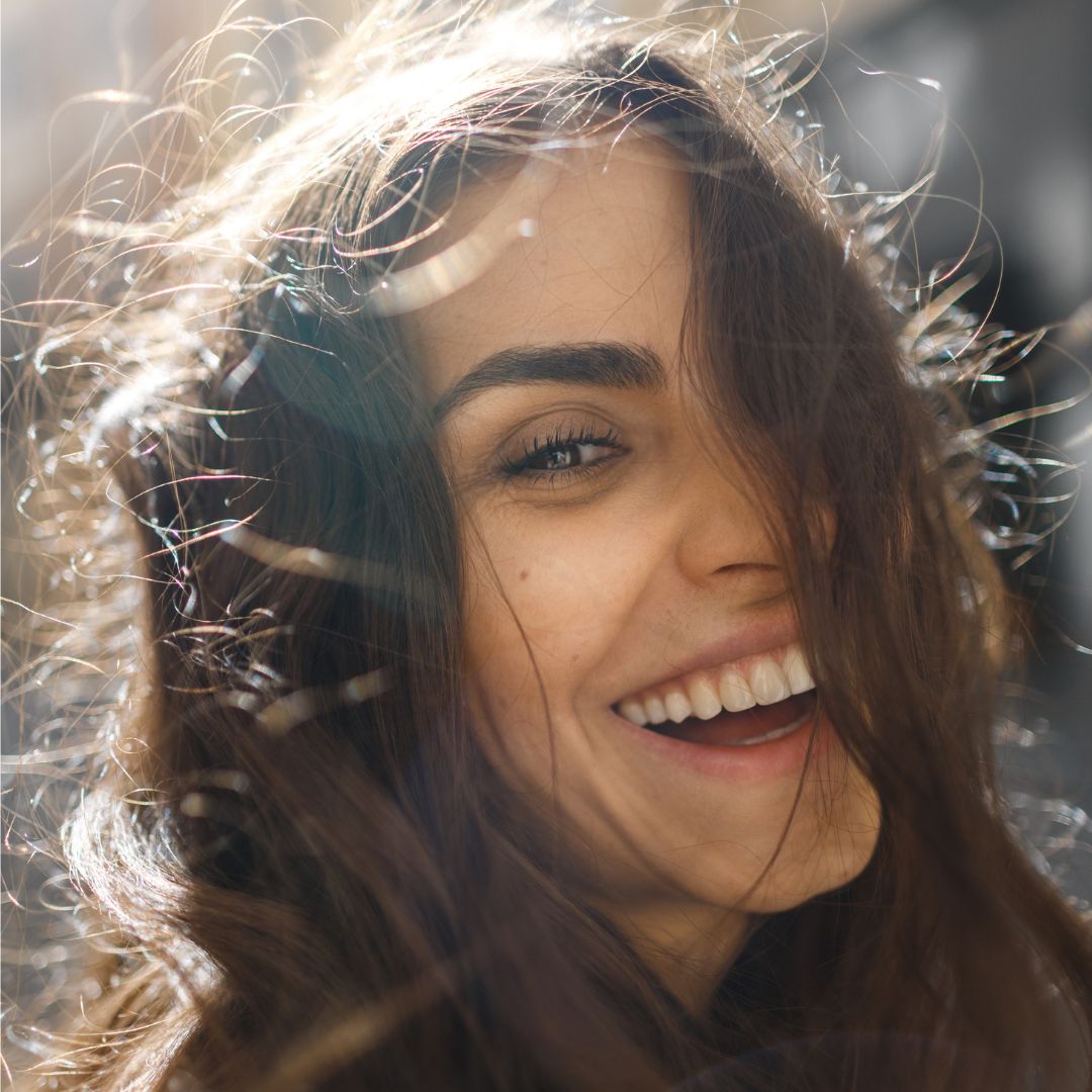 best eyebrow pens - Woman with full brows smiling at the camera - getty images 1390104940